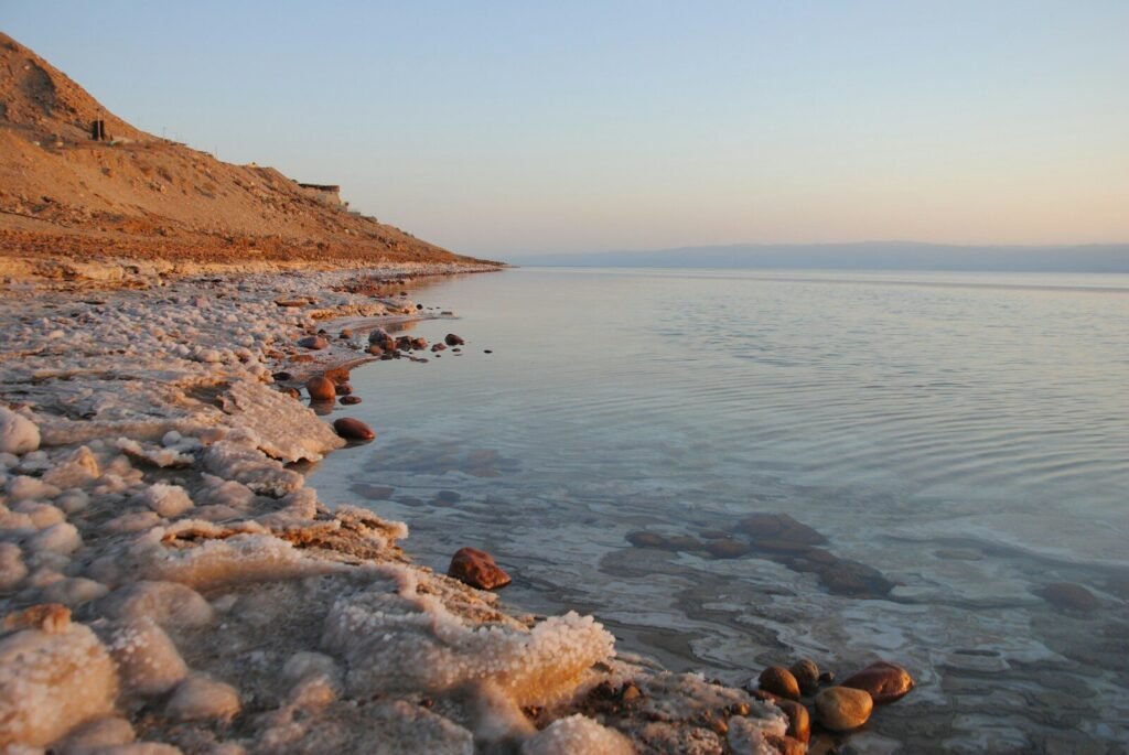 The sea's shoreline is illuminated by the sun.