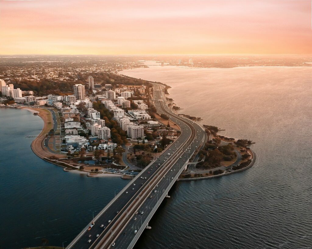 aerial view of city buildings near body of water during daytime