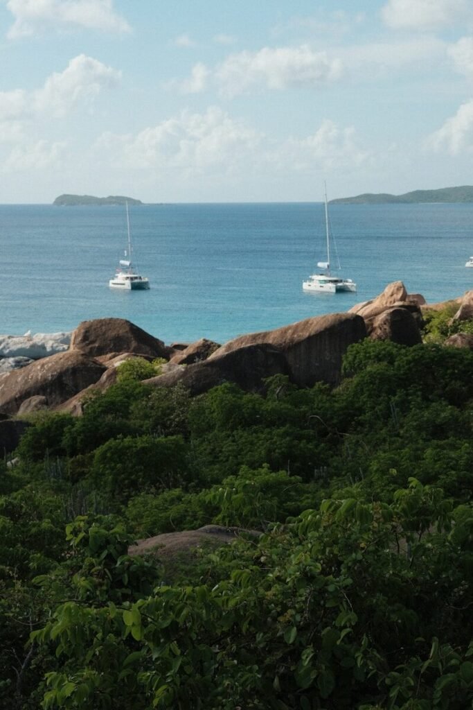 a couple of boats floating on top of a body of water