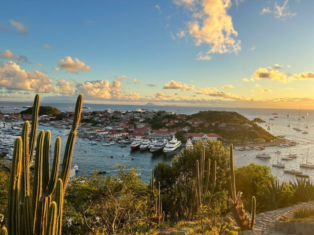 The sun is setting over a harbor with boats in the water